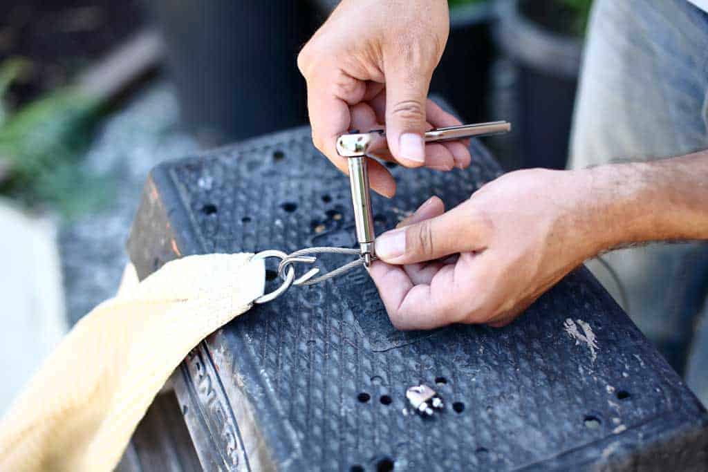 tightening the nuts on the cable clamps