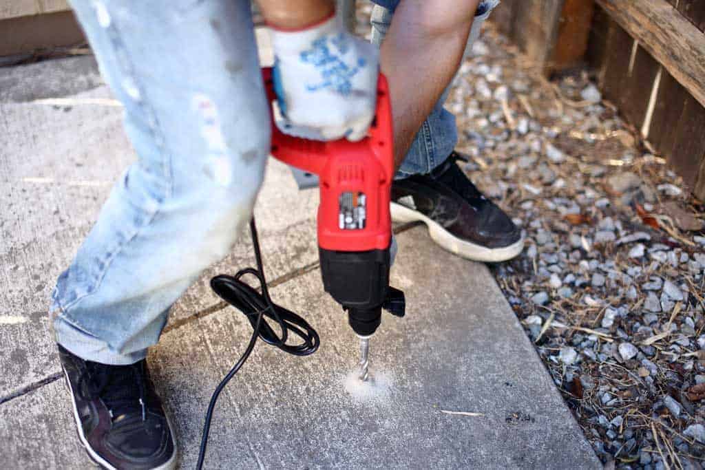 drilling a hole in the concrete