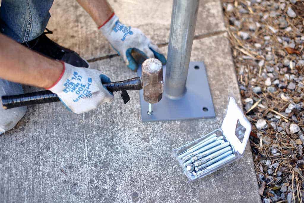 hammering anchors into the concrete