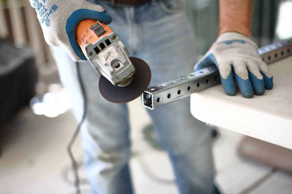 using grinder to cut support of zip line