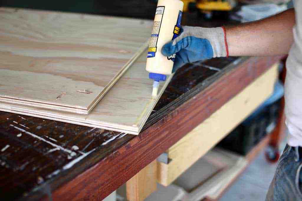 applying wood glue to the back board