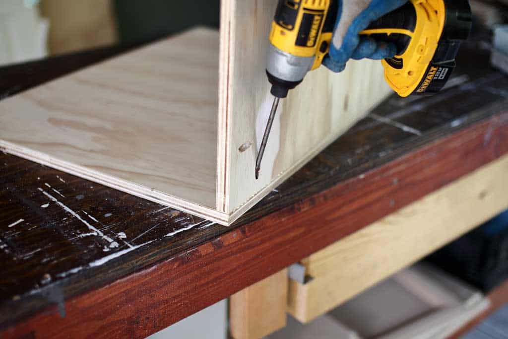 attaching backboard to the bottom of the diy backroom cabinet