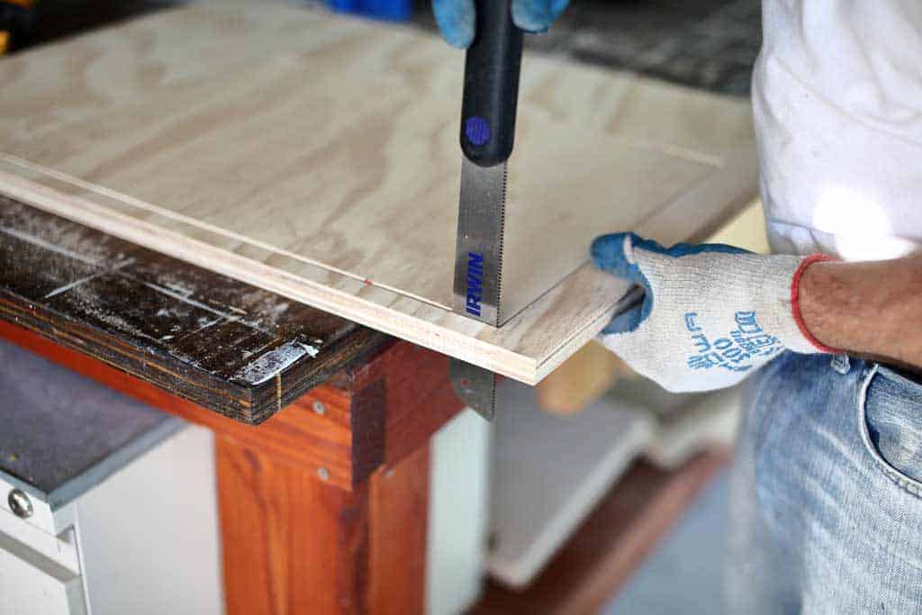 using dovetail saw to cut out opening for drawer