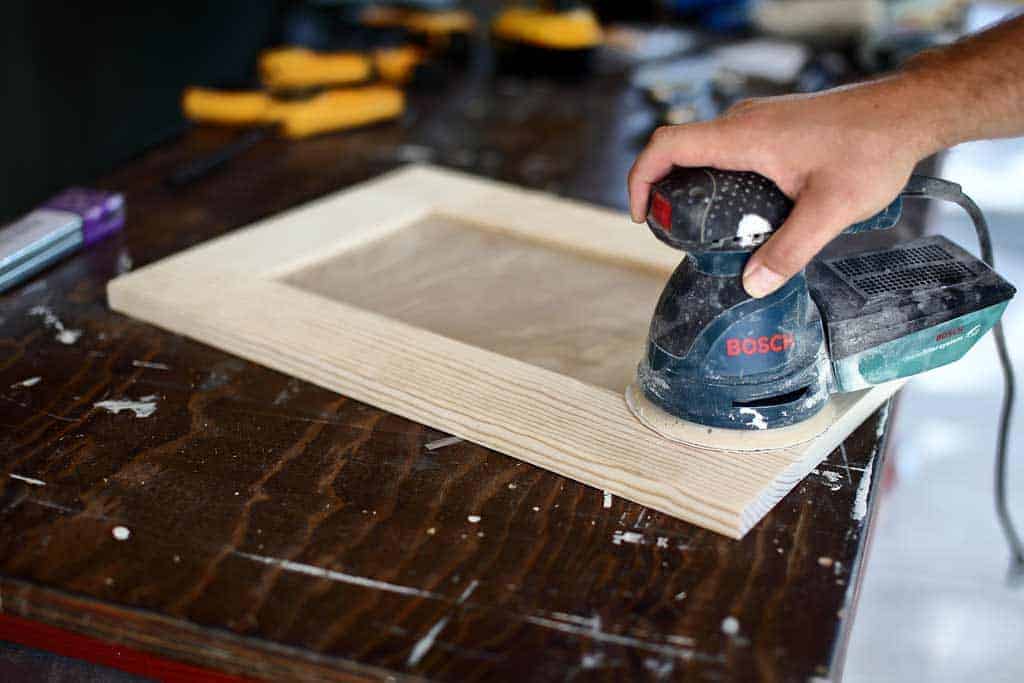 using random orbital sanding to sand cabinet door