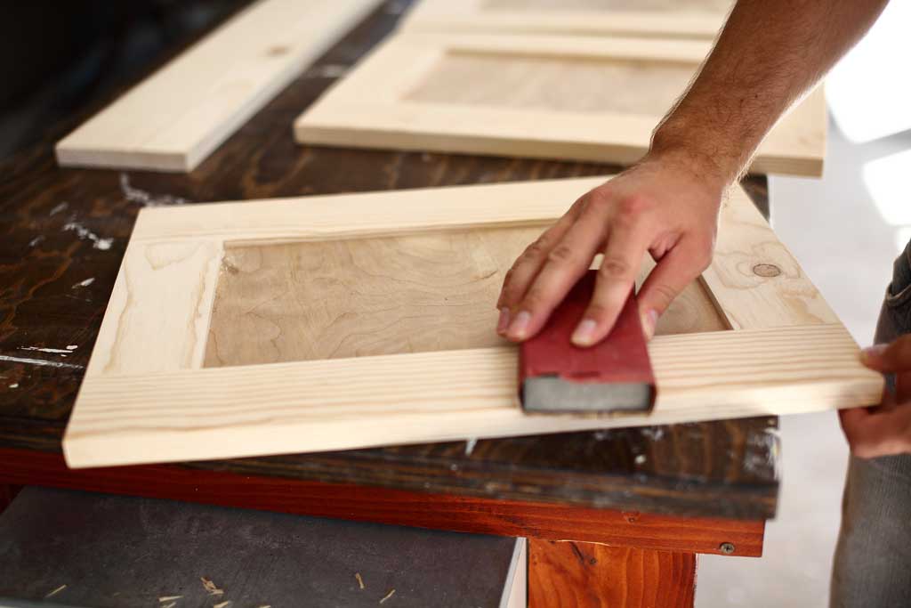 sanding cabinet door with sandpaper