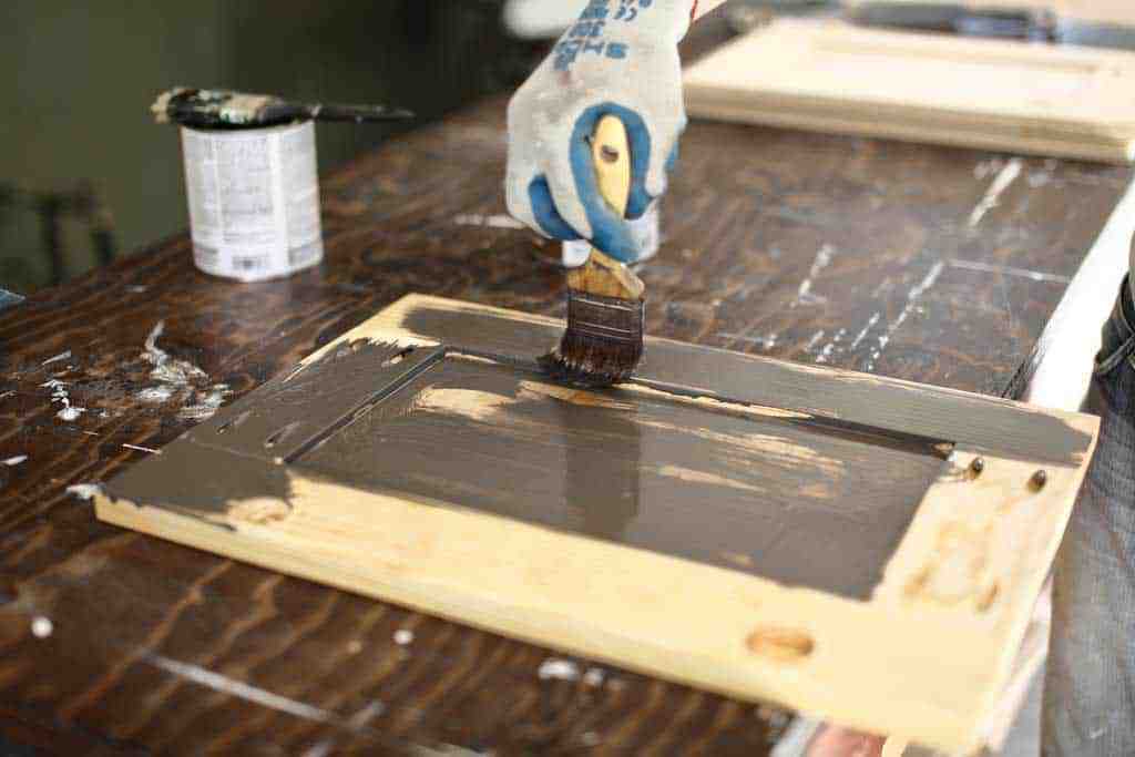 applying stain to the cabinet door