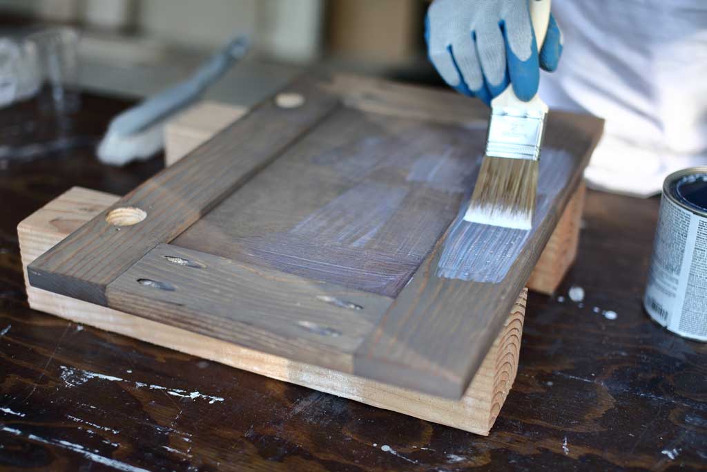 applying polyurethane to the cabinet door