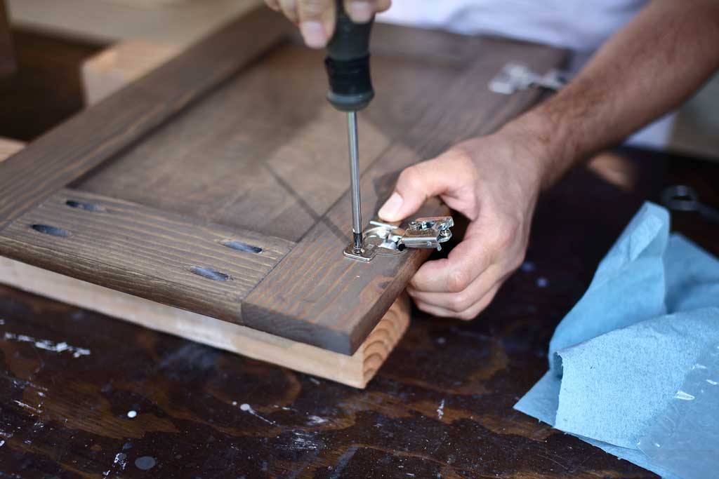 attaching hinges to the cabinet door
