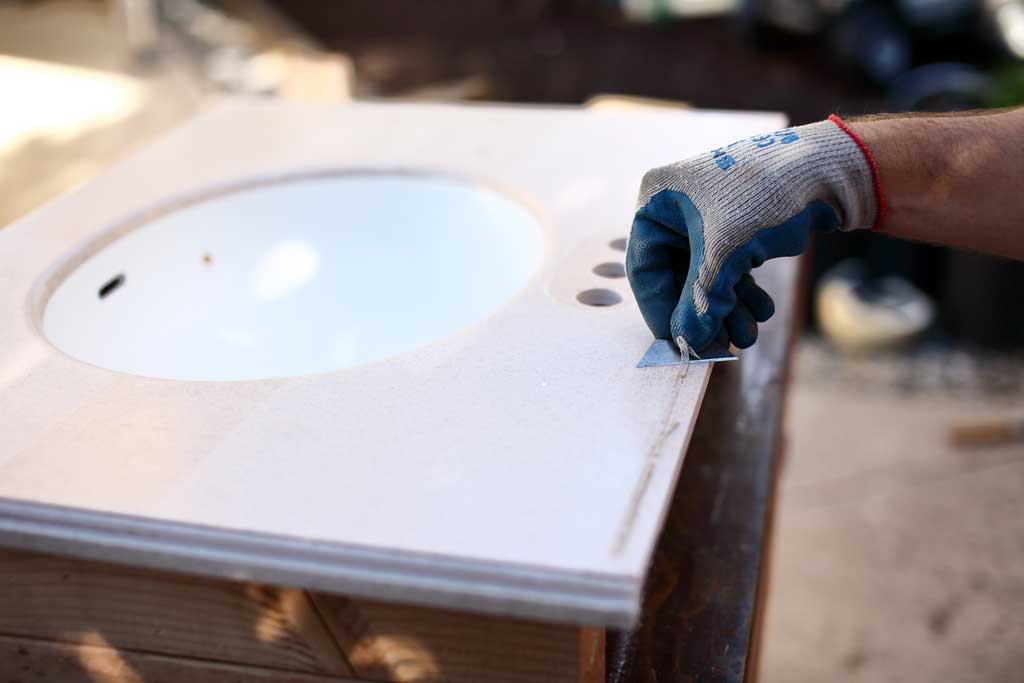 removing caulking from old vanity top