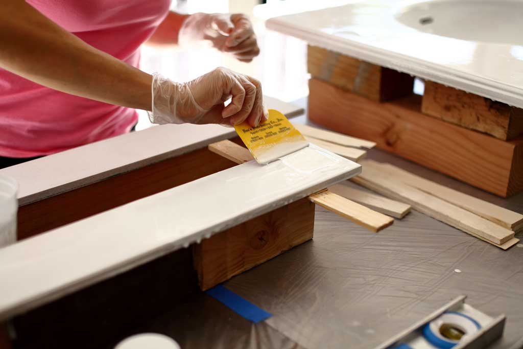 spreading epoxy over the backsplash