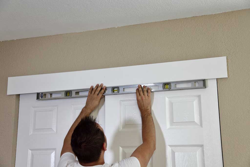 leveling decor board over the closet doors