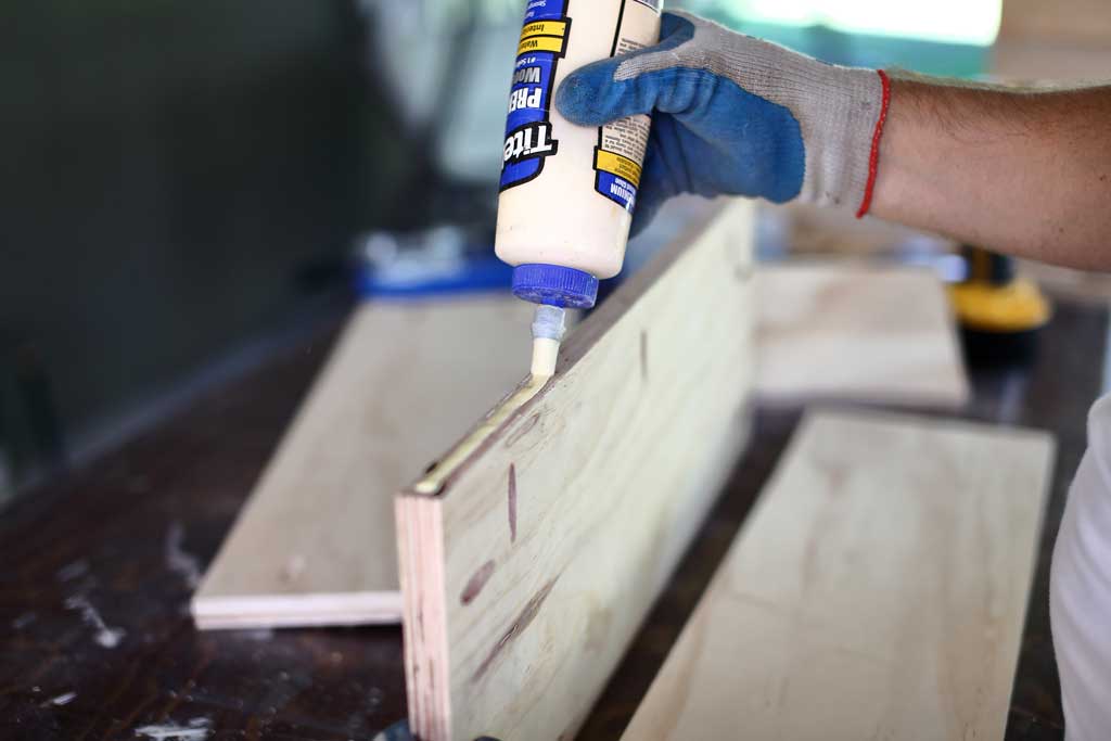 applying glue to the plywood