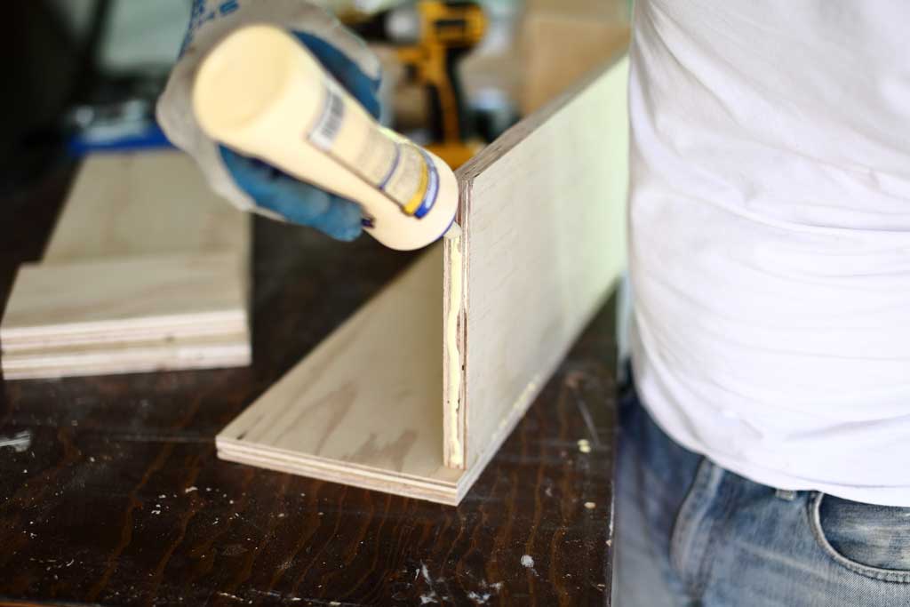 applying glue on the side of the diy flower planter box