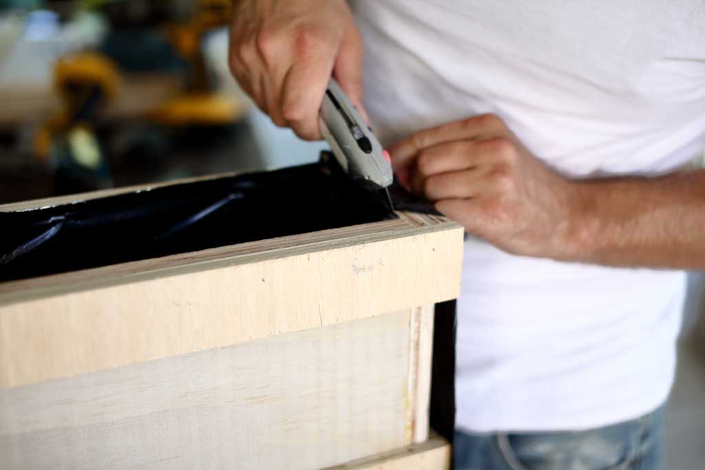 cutting off extra liner from diy flower planter box