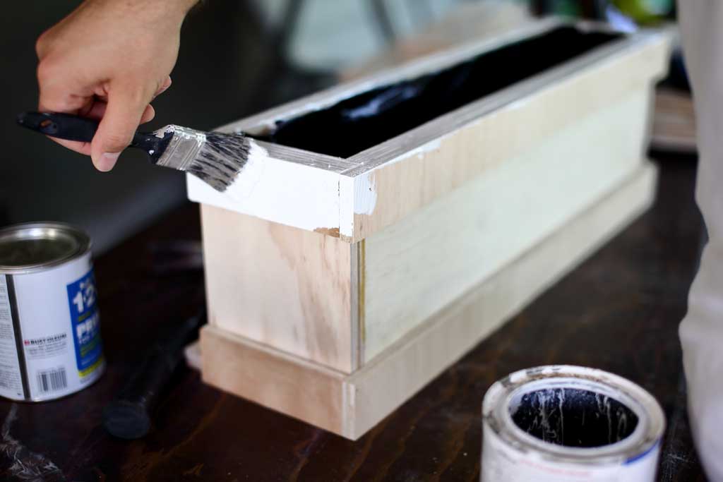 applying primer on diy flower planter box