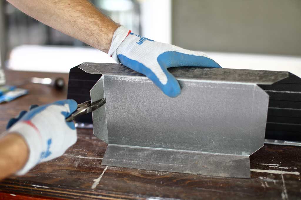 using pliers to bend flanges on gutter for the DIY pyramid gutter planter