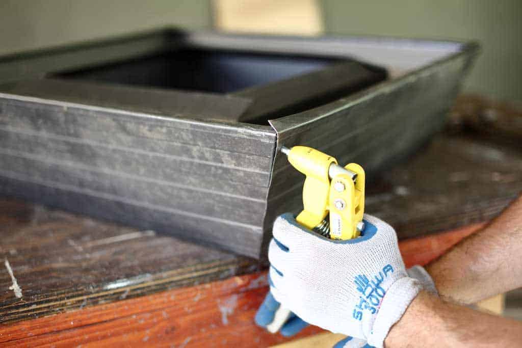 using pop rivet tool to join the corner of gutter