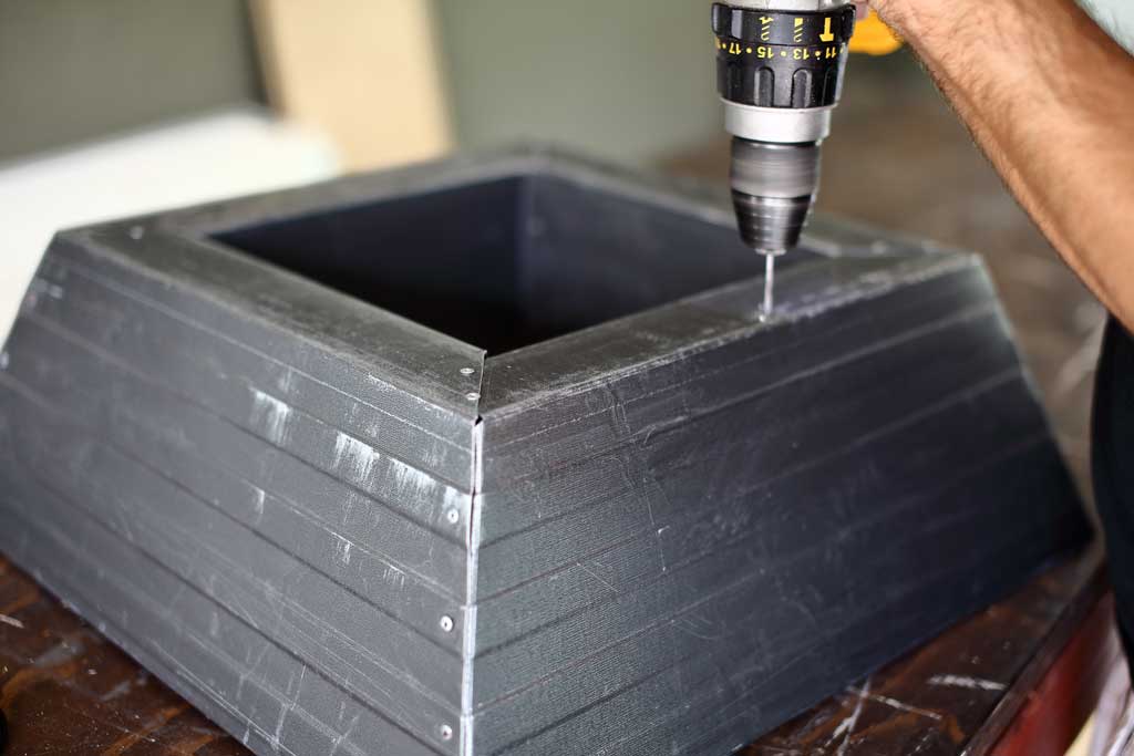 drilling holes in the bottom for water drainage