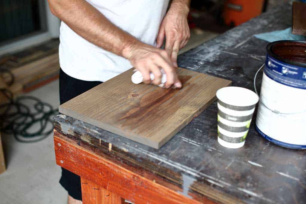 applying a coat of paint over the board
