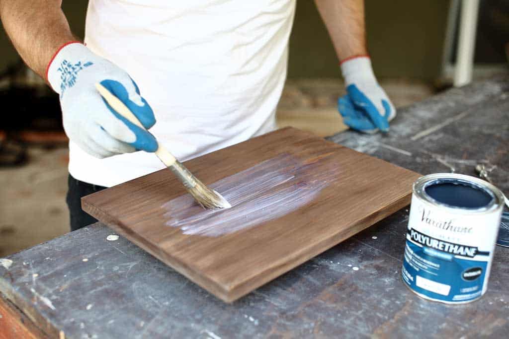 applying polyurethane on a board for diy jar organizer