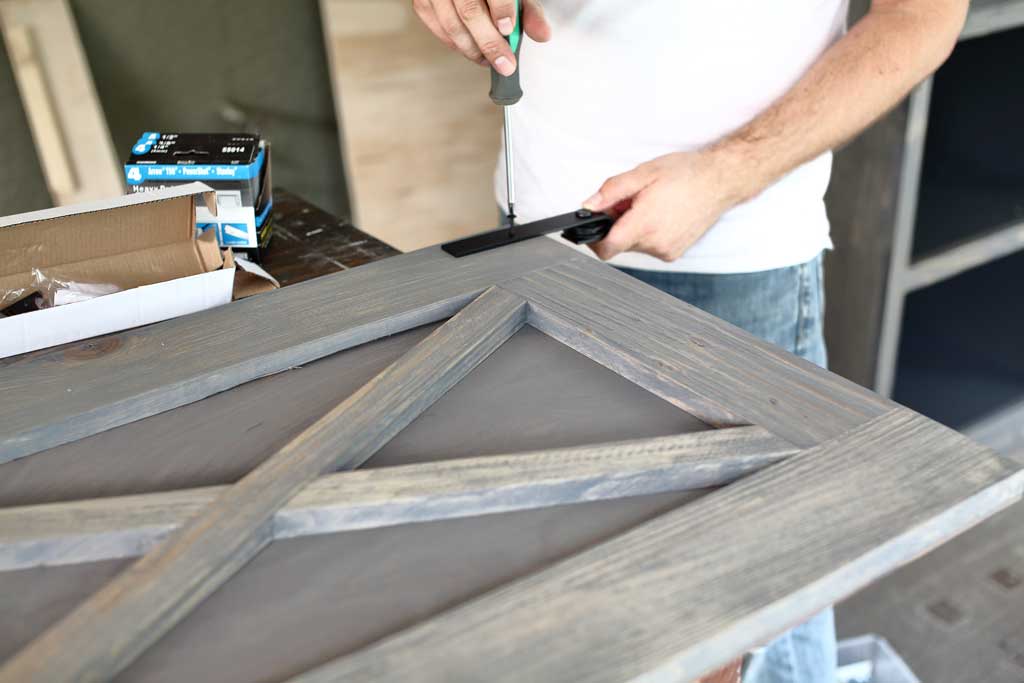 attaching roller to farmhouse door for media center