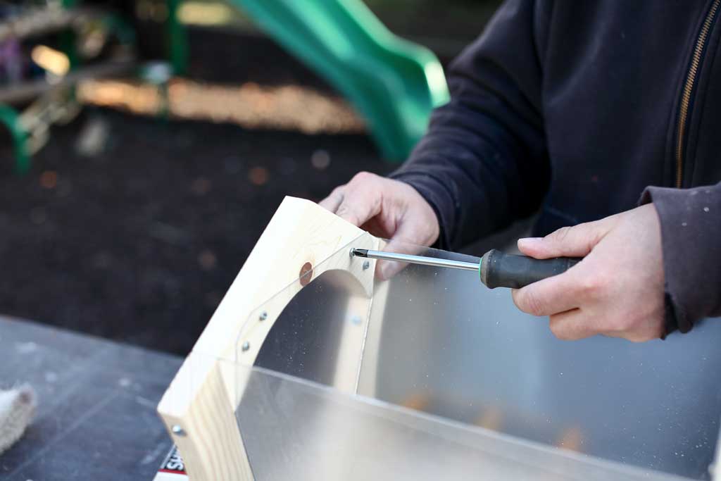 using screw driver to attach thermoplastic sheets