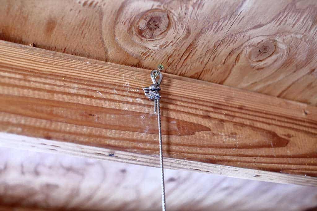 aircraft cable hooked on a screw