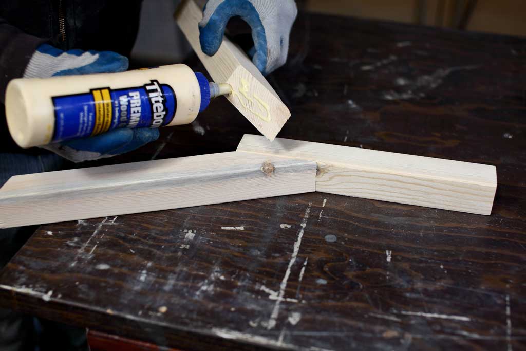 applying wood glue to boards
