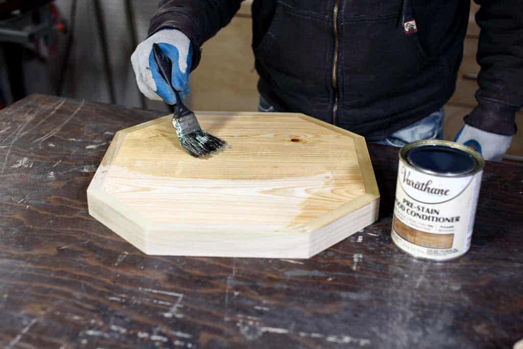 applying pre-stain to table top