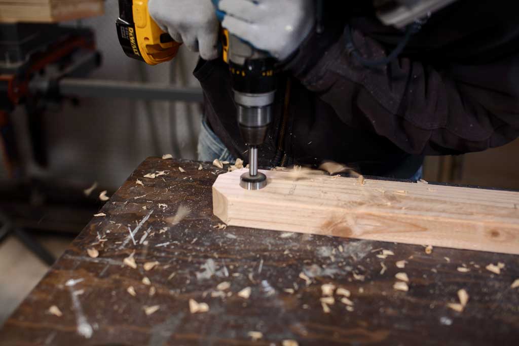 drilling holes in 2x4 for ladder toss game