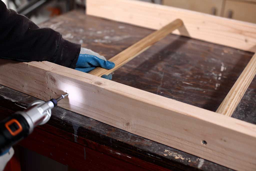 driving in the screw for DIY wooden ladder toss game