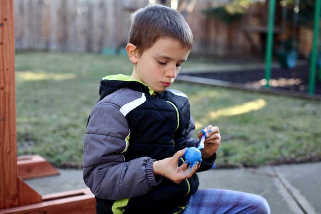 kid painting the golf ball