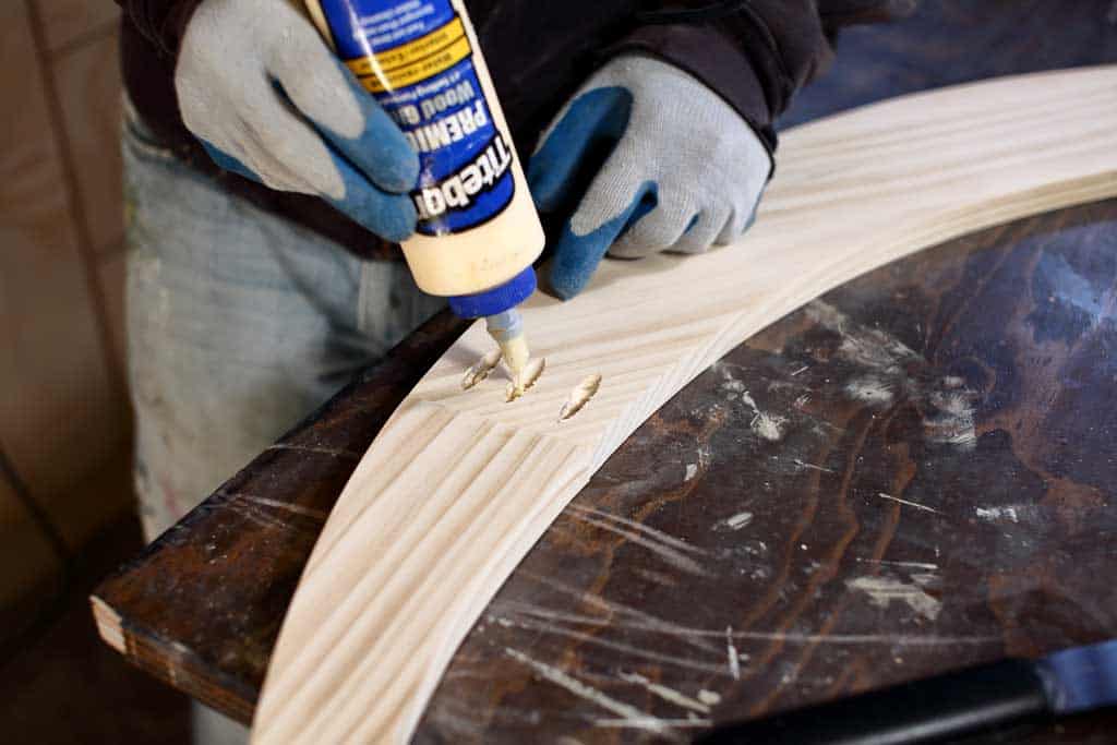 applying wood glue into the pocket holes