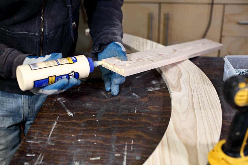 applying wood glue to rocker pieces