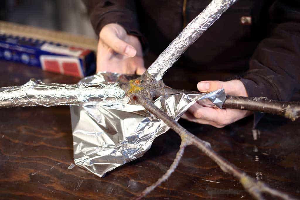 wrapping tree twigs with foil for fairy tree