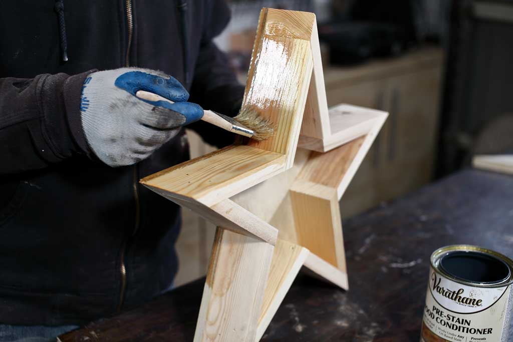 applying pre-stain on star planter