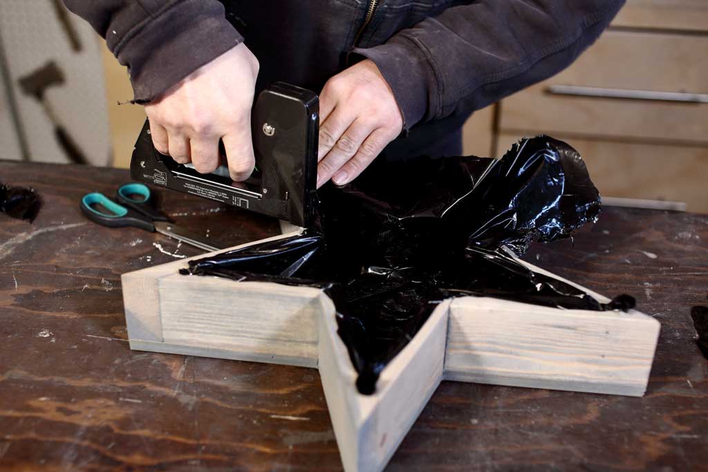 attaching plastic sheeting inside the planter