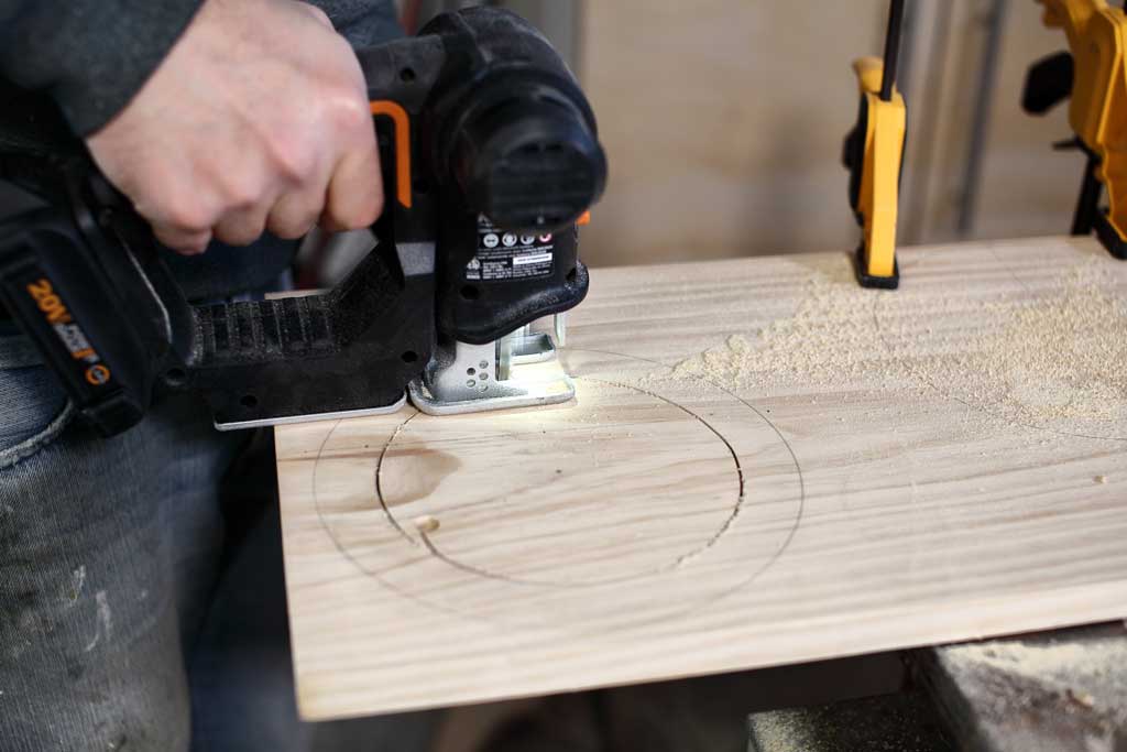 cutting out circle with jig saw on wood