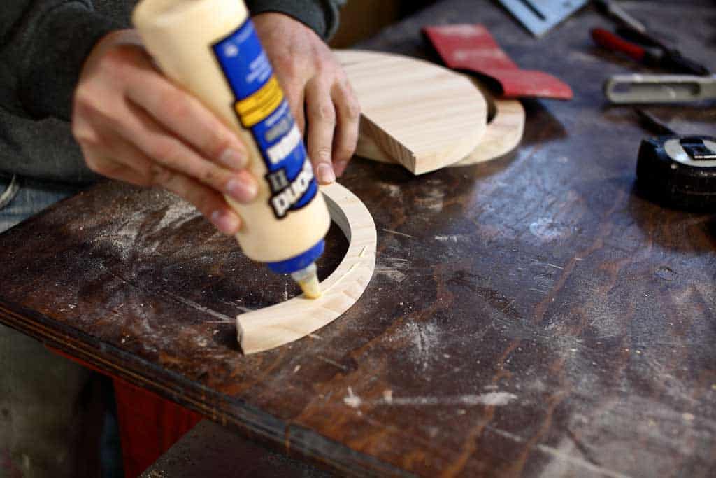 applying wood glue on wood