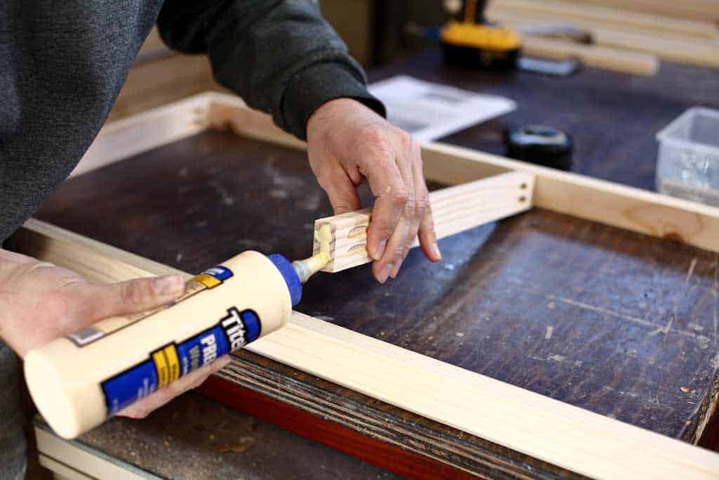 applying wood glue to wood