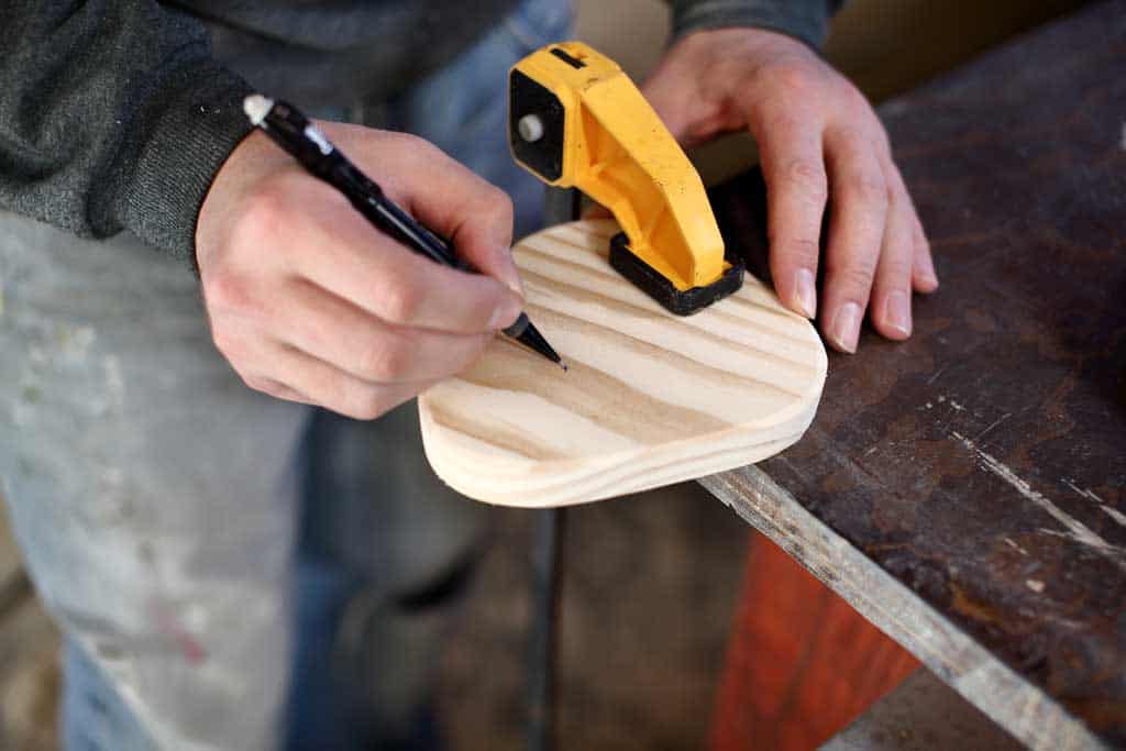 marking a tik mark where to drill holes