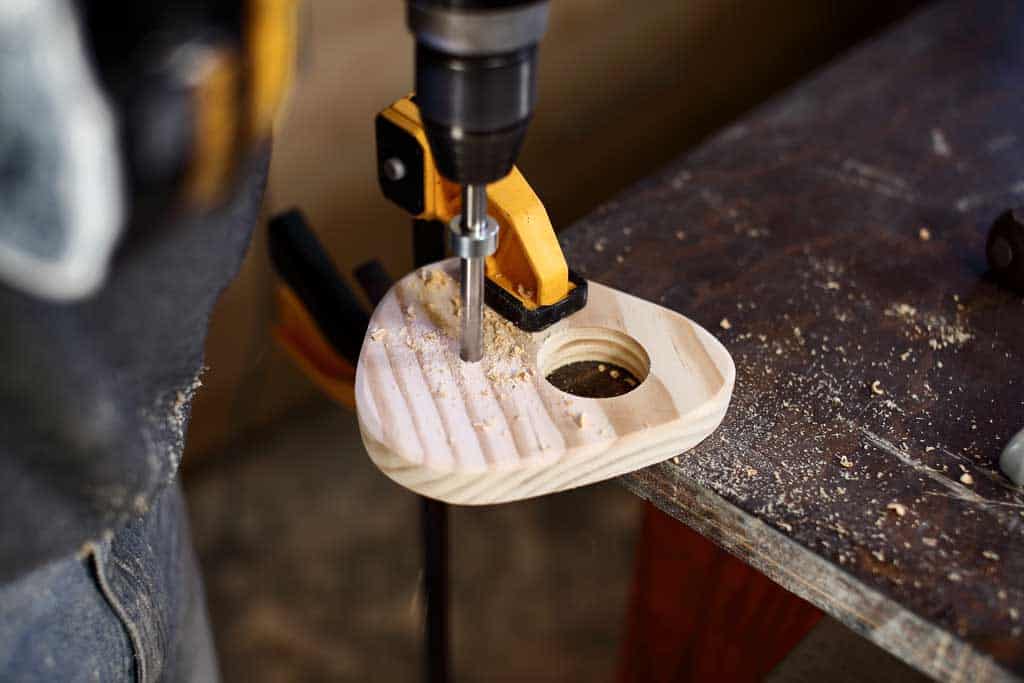 drilling hole in the board for the birdhouse