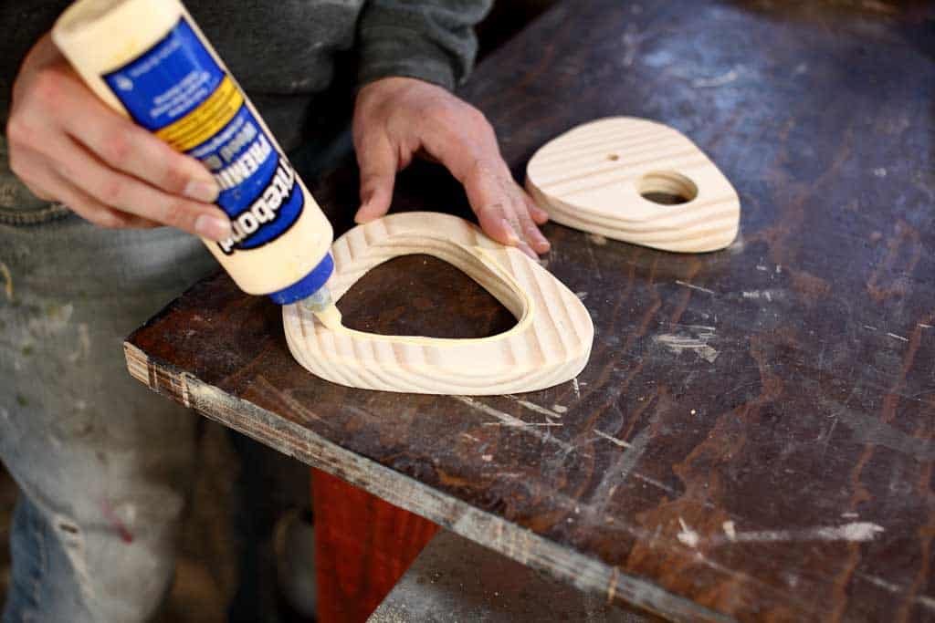 applying wood glue to board