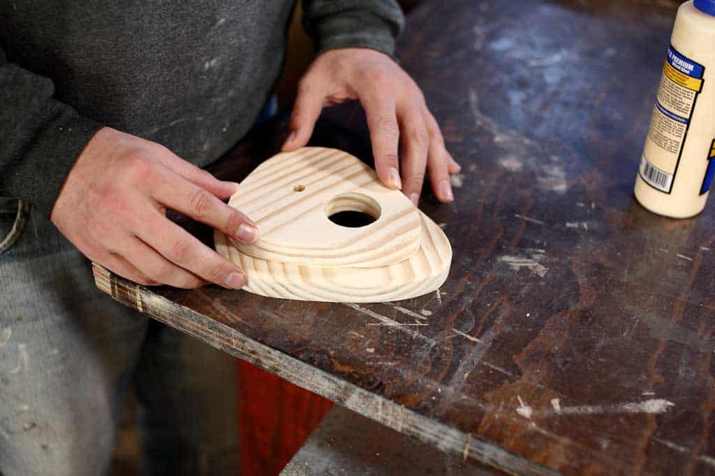 gluing the front piece of the birdhouse