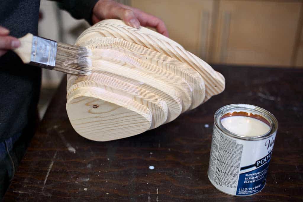 applying polyurethane to birdhouse