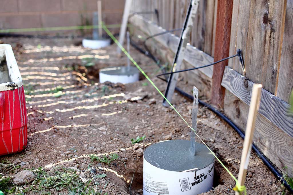 filling tubes with concrete for DIY Garden Arbor with a Bench