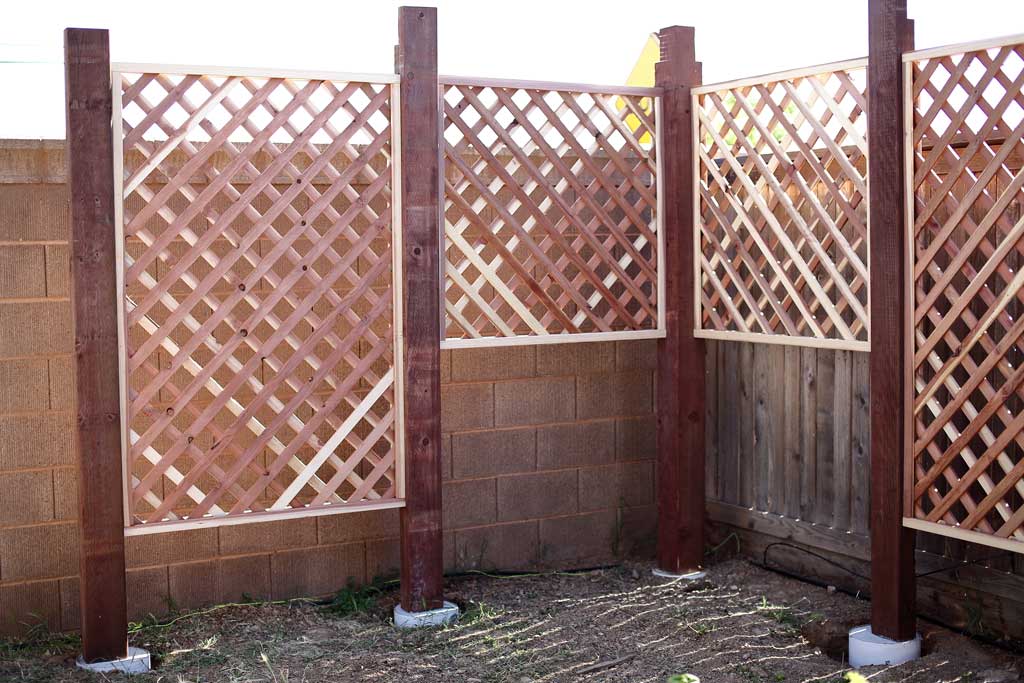 installing trellis for DIY Garden Arbor with a Bench