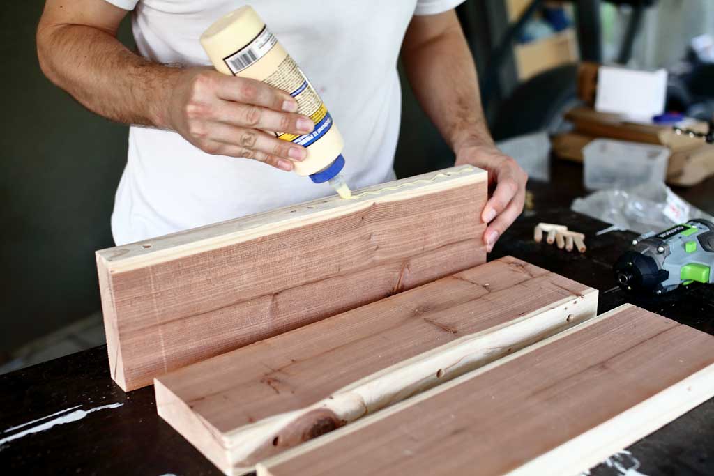 applying wood glue to join the boards