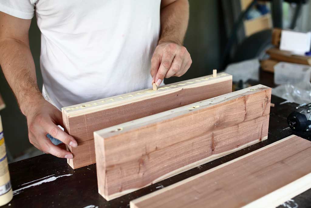 inserting dowels into the holes