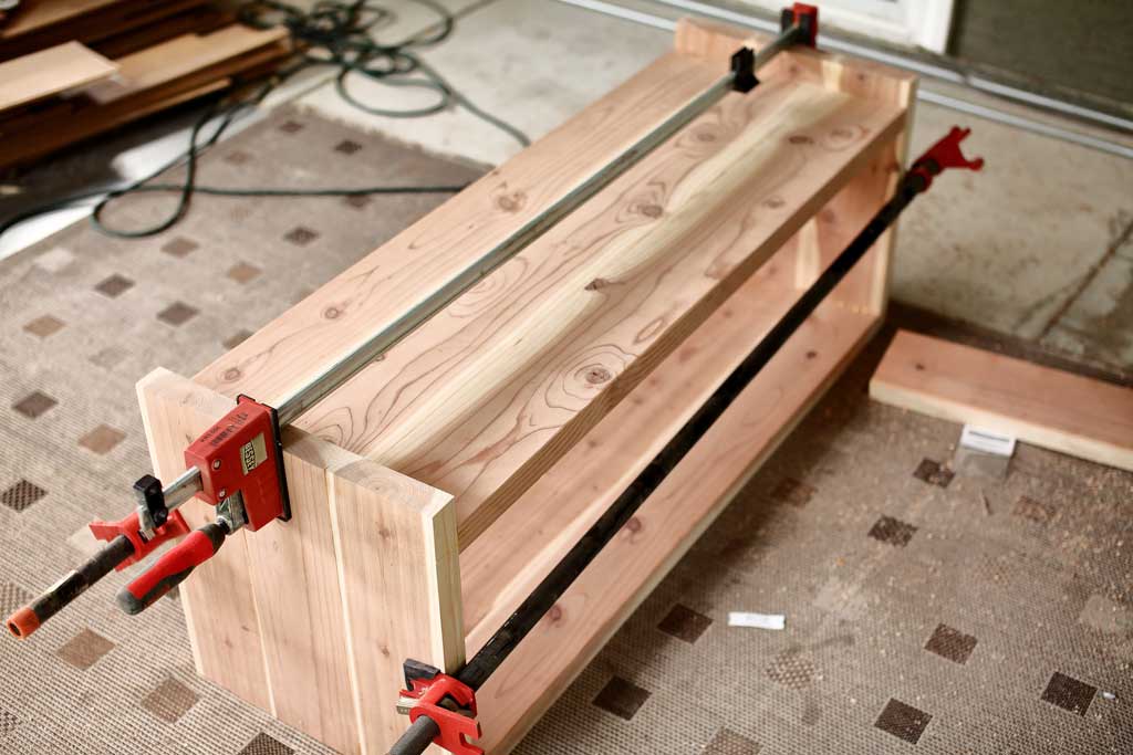 clamping the bench together for glue to dry